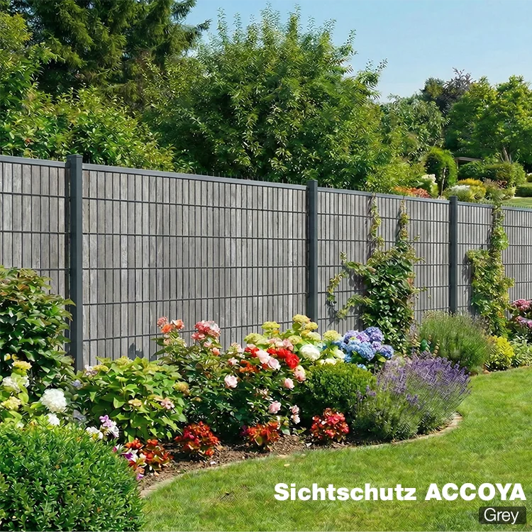 Sichtschutzzaun Accoya in Grey als Gartenzaun mit blühendem Beet im Hintergrund
